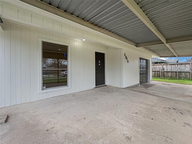 property entrance featuring a patio area and fence