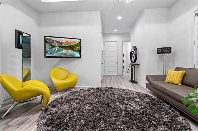 interior space with a skylight and light hardwood / wood-style floors