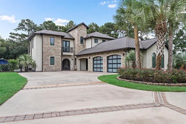 view of front of property with a garage and a balcony