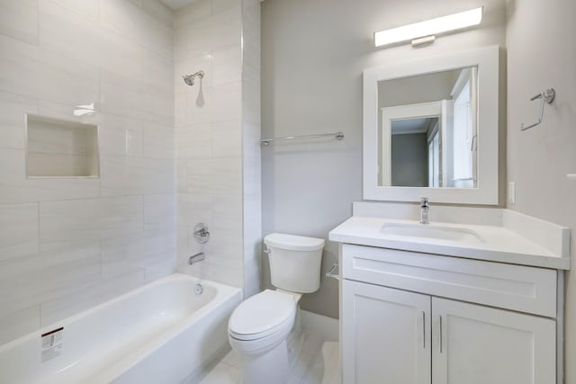 full bathroom featuring tiled shower / bath combo, vanity, and toilet