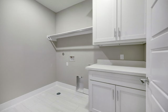 laundry room with cabinets, hookup for an electric dryer, and hookup for a washing machine