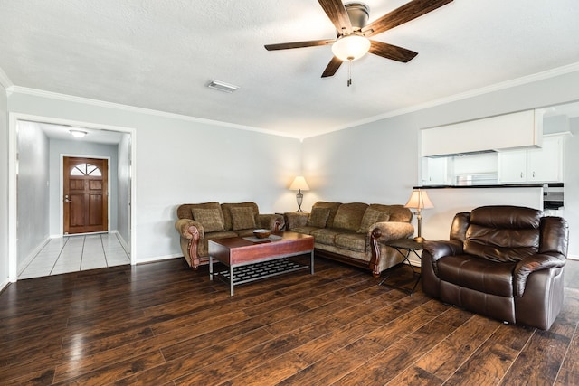 living room with ceiling fan, ornamental molding, wood-type flooring, and a textured ceiling