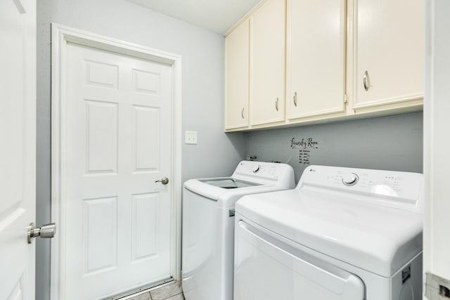 laundry area with washer and dryer and cabinets