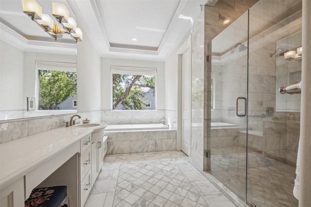 bathroom with ornamental molding, plenty of natural light, plus walk in shower, and a raised ceiling