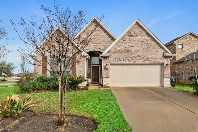 view of front of house with a garage and a front lawn