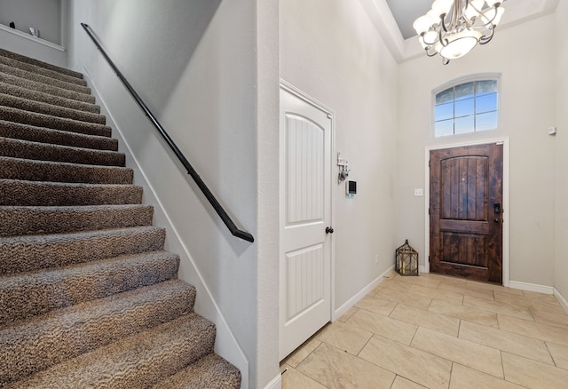 entryway with an inviting chandelier and a high ceiling