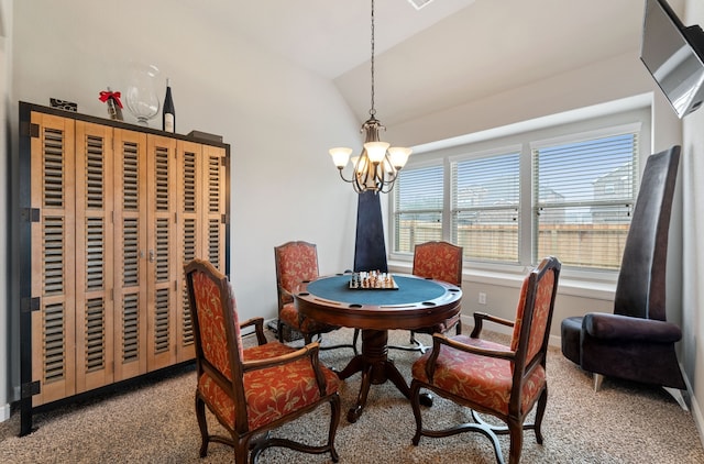 dining space featuring carpet floors, vaulted ceiling, and a chandelier