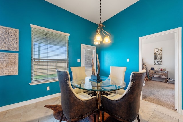 dining space with light tile patterned flooring and a chandelier