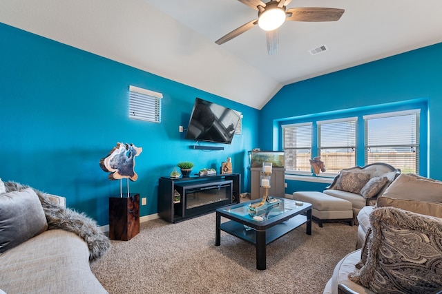 carpeted living room with ceiling fan and lofted ceiling