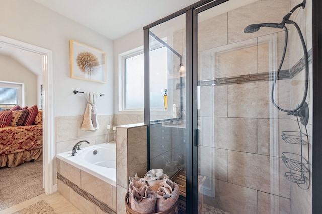 bathroom featuring separate shower and tub