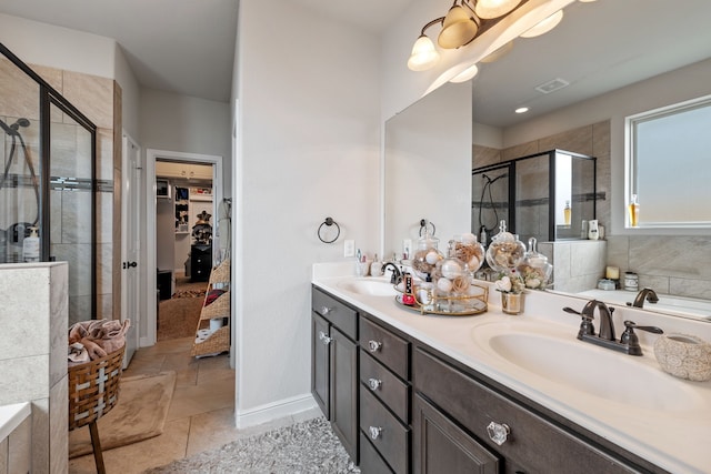 bathroom with an enclosed shower, vanity, and tile patterned floors