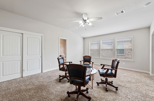 carpeted office featuring vaulted ceiling and ceiling fan