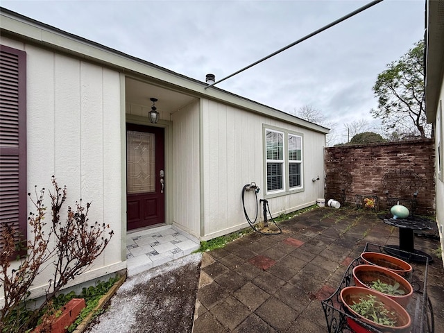 entrance to property with a patio area