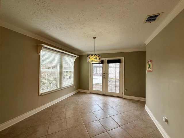 unfurnished dining area featuring ornamental molding, french doors, a textured ceiling, and light tile patterned flooring