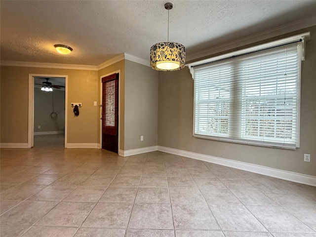 tiled empty room with ceiling fan, ornamental molding, and a textured ceiling