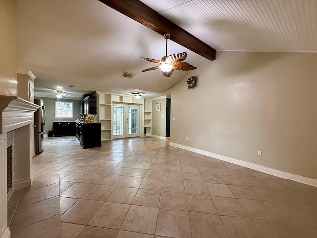 unfurnished living room featuring lofted ceiling with beams, light tile patterned flooring, ceiling fan, and french doors