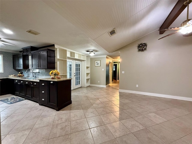 kitchen featuring sink, light tile patterned floors, ceiling fan, light stone countertops, and vaulted ceiling