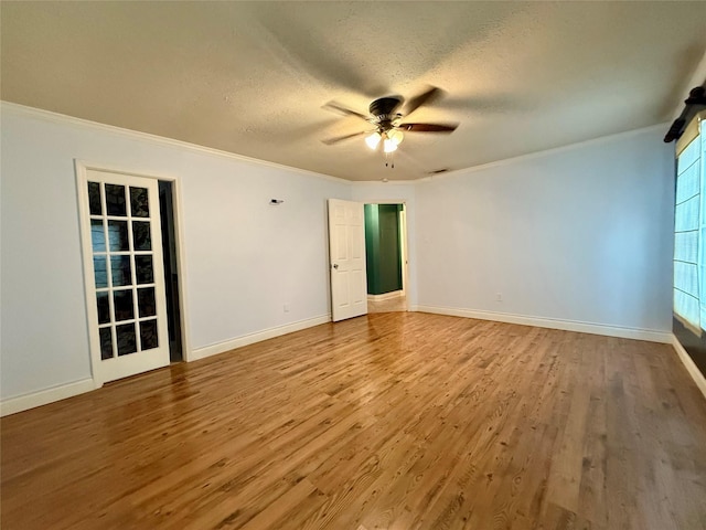 unfurnished room featuring crown molding, ceiling fan, wood-type flooring, and a textured ceiling