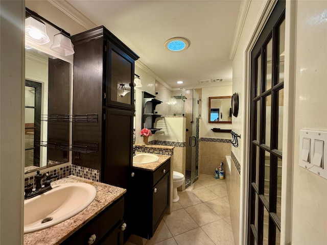 bathroom with tile patterned flooring, an enclosed shower, vanity, ornamental molding, and toilet