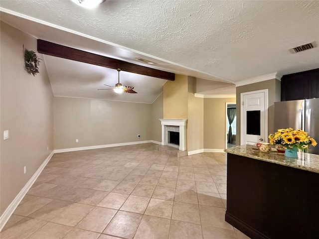 unfurnished living room with light tile patterned flooring, ceiling fan, a textured ceiling, and vaulted ceiling with beams