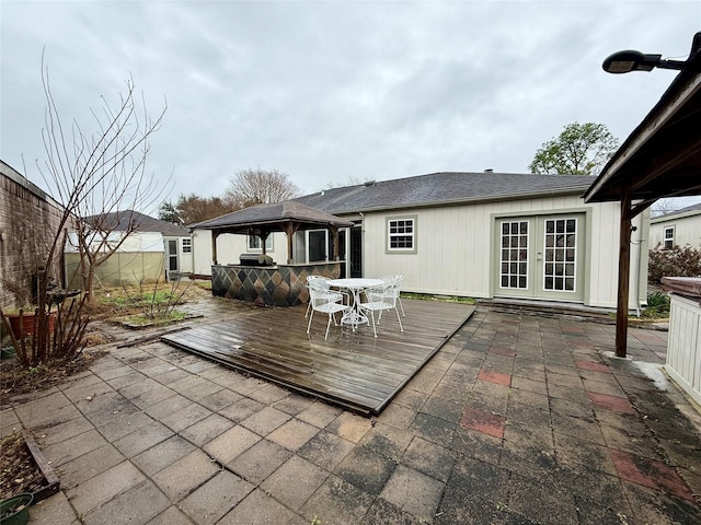 rear view of property with a gazebo, french doors, and a deck