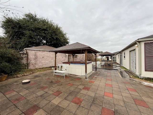 view of patio / terrace featuring a gazebo and a hot tub