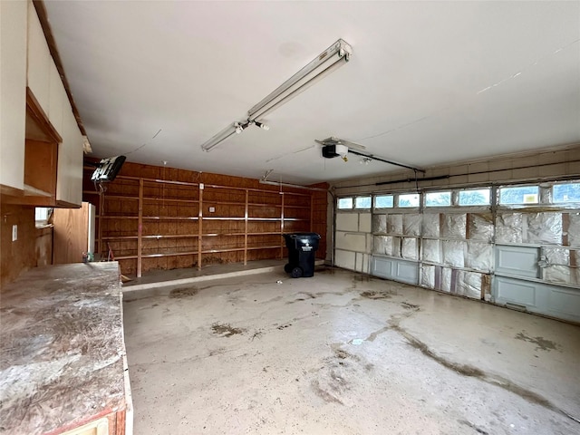 garage with a garage door opener and fridge