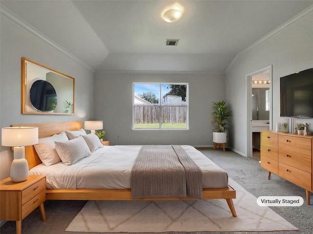 bedroom featuring visible vents, ornamental molding, connected bathroom, and light colored carpet