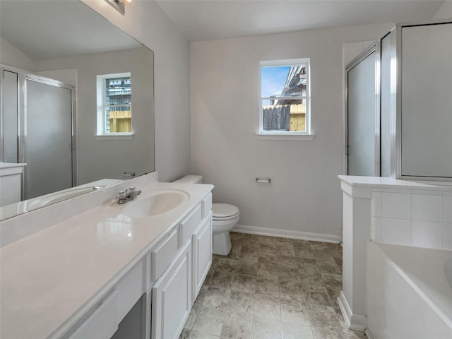 full bathroom with a garden tub, toilet, vanity, baseboards, and a shower stall