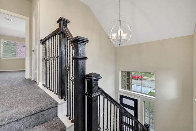 stairs featuring visible vents, baseboards, carpet flooring, high vaulted ceiling, and a notable chandelier