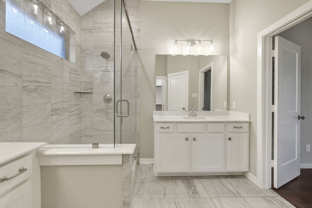 full bathroom featuring marble finish floor, a shower stall, vanity, and baseboards