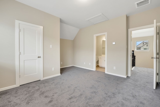 unfurnished bedroom with light carpet, baseboards, visible vents, and attic access