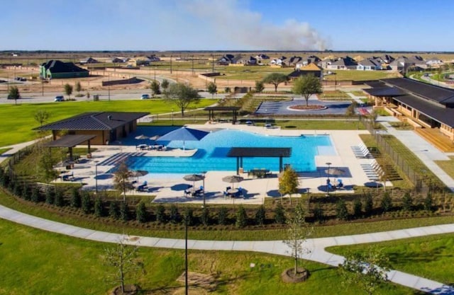 pool featuring a patio area and a residential view