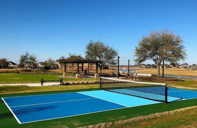 view of sport court featuring a tennis court and a gazebo