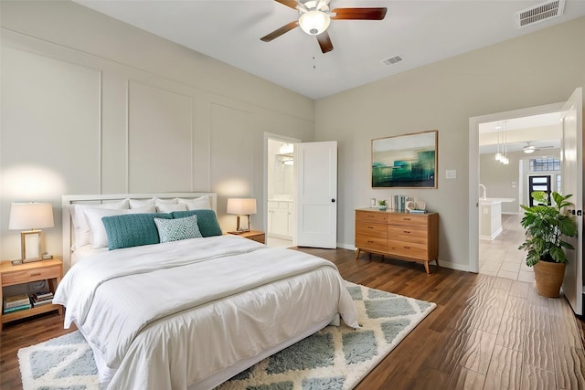 bedroom featuring baseboards, visible vents, ceiling fan, and dark wood-type flooring