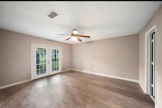 spare room featuring french doors, ceiling fan, and dark hardwood / wood-style floors