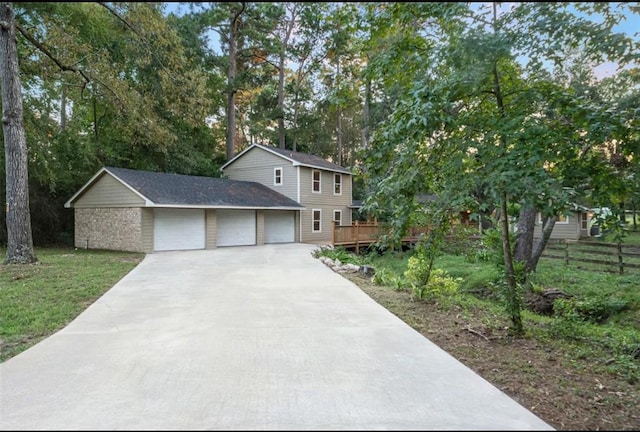 view of front facade featuring a garage, a front yard, and a deck