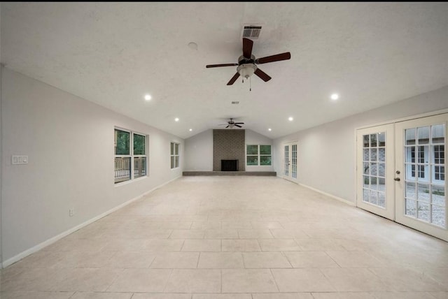 unfurnished living room with ceiling fan, a fireplace, a textured ceiling, vaulted ceiling, and french doors