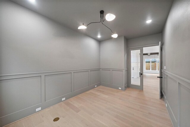 8545 Ridgepoint Dr, Houston, TX 77055 - unfurnished room featuring a decorative wall, light wood-type flooring, wainscoting, and recessed lighting