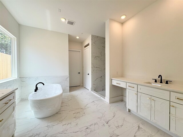 8545 Ridgepoint Dr, Houston, TX 77055 - bathroom with tile walls, a marble finish shower, vanity, a freestanding bath, and marble finish flooring