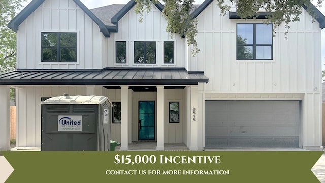 8545 Ridgepoint Dr, Houston, TX 77055 - view of front facade featuring a standing seam roof, an attached garage, metal roof, board and batten siding, and a porch
