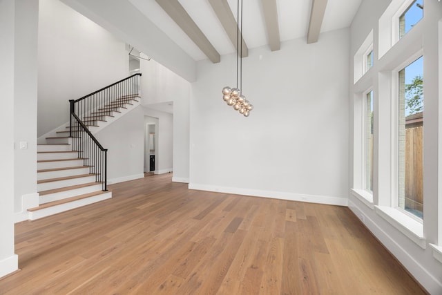 8545 Ridgepoint Dr, Houston, TX 77055 - entryway with light wood-style floors, stairway, a towering ceiling, and beamed ceiling