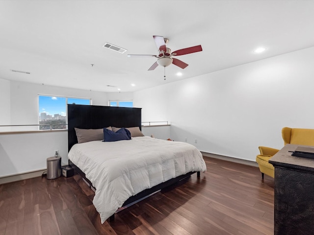 bedroom with dark wood-type flooring and ceiling fan