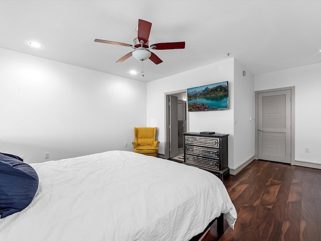 bedroom with ceiling fan and dark hardwood / wood-style flooring