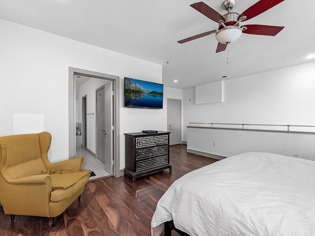 bedroom featuring dark wood-type flooring, ensuite bath, and ceiling fan