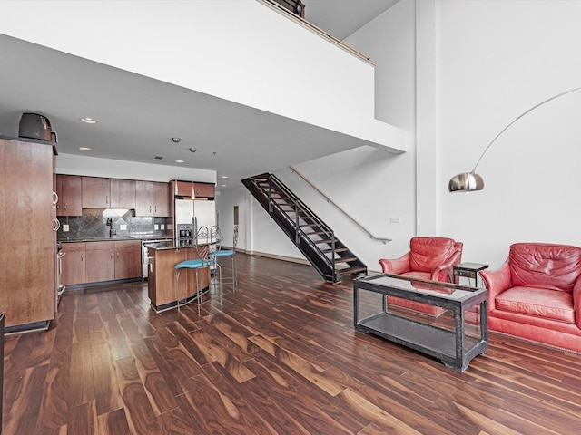 living room with dark hardwood / wood-style floors and sink