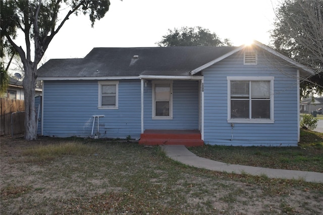 rear view of house with a yard