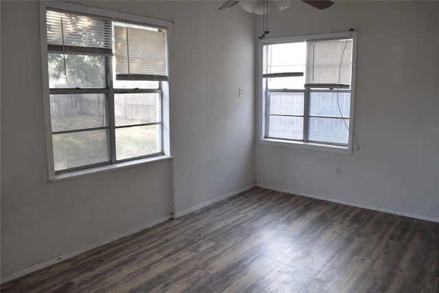 unfurnished room with dark wood-type flooring and ceiling fan