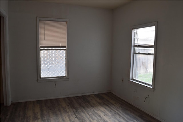 unfurnished room with dark hardwood / wood-style floors