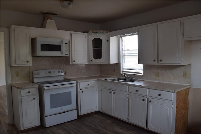 kitchen featuring dark wood-type flooring, sink, tasteful backsplash, white appliances, and white cabinets